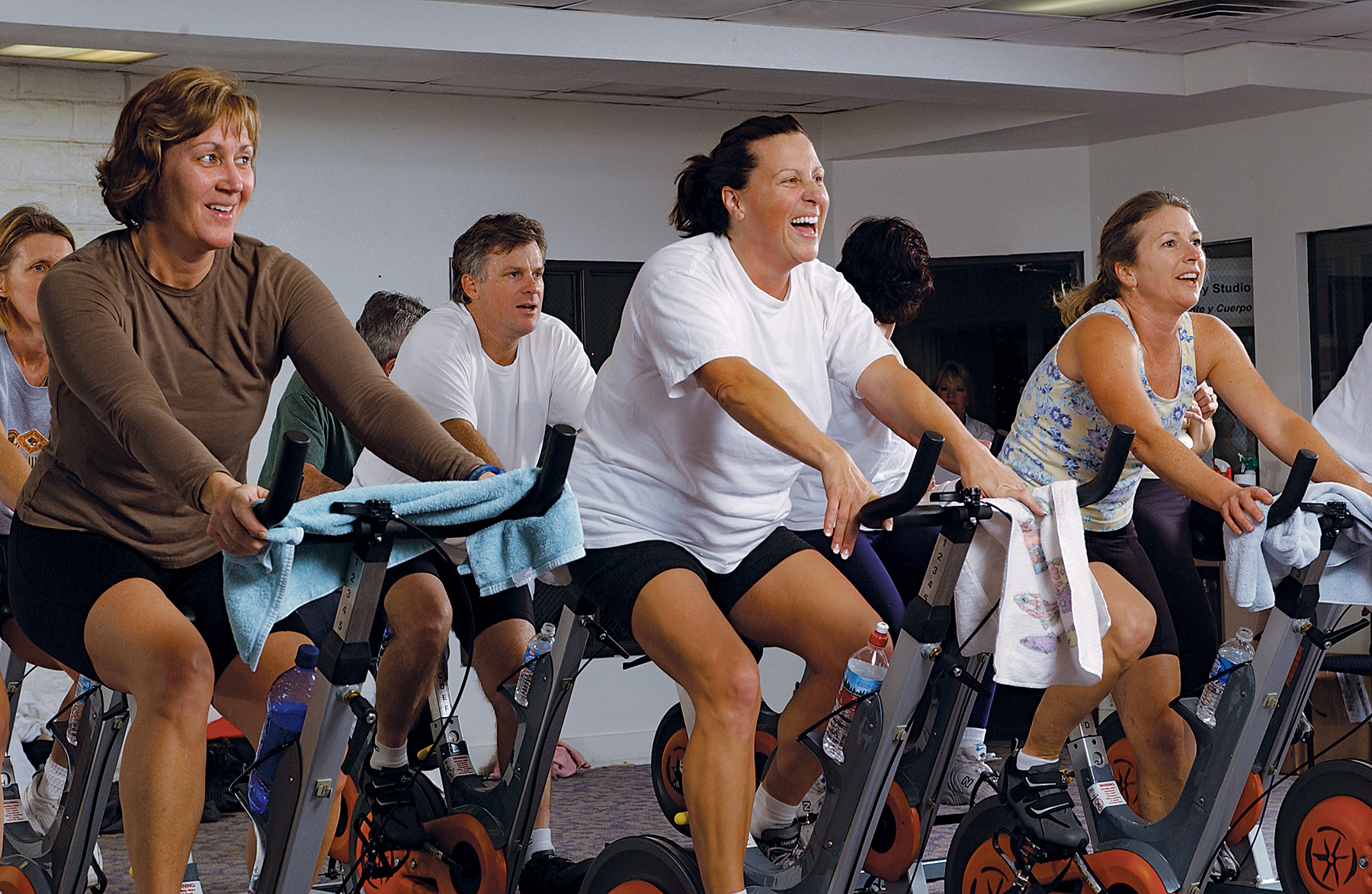 Adults in a cycling fitness class.