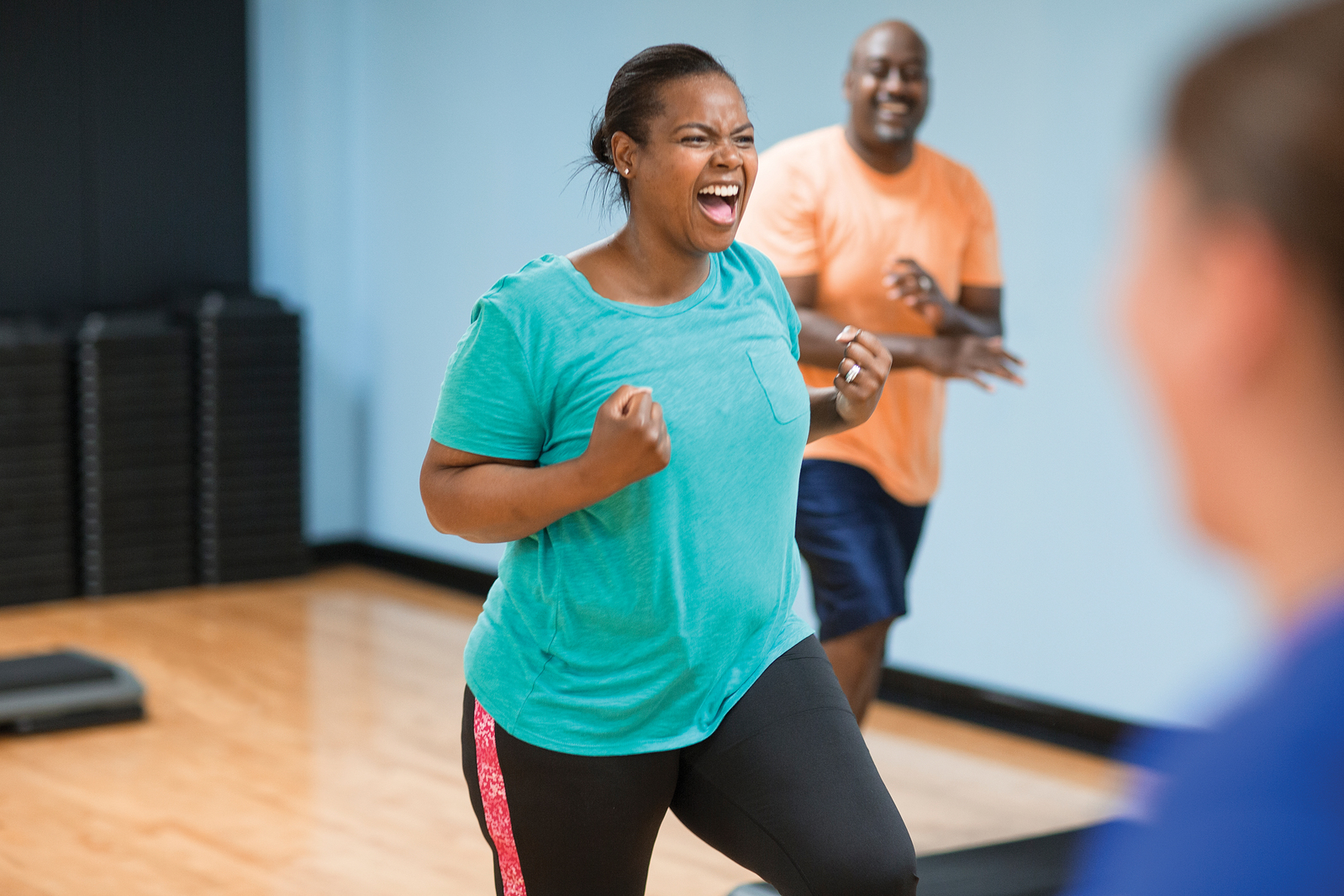 Exciting women and man in fitness class.