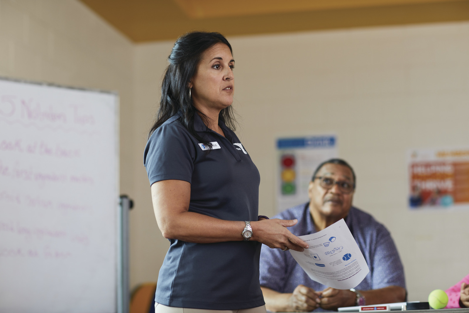 YMCA staff member explaining things to a class.