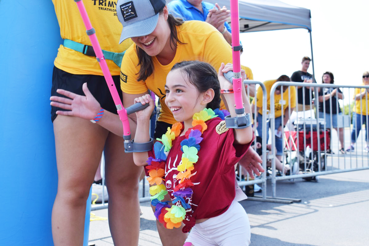 Young girl running the the YMCA triathlon.