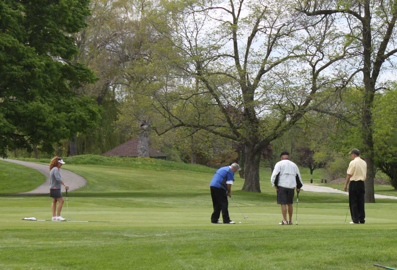 Woman and men on the annual golf outing.