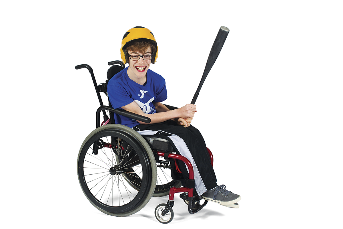 Guy in wheel chair smiling holding a bat.