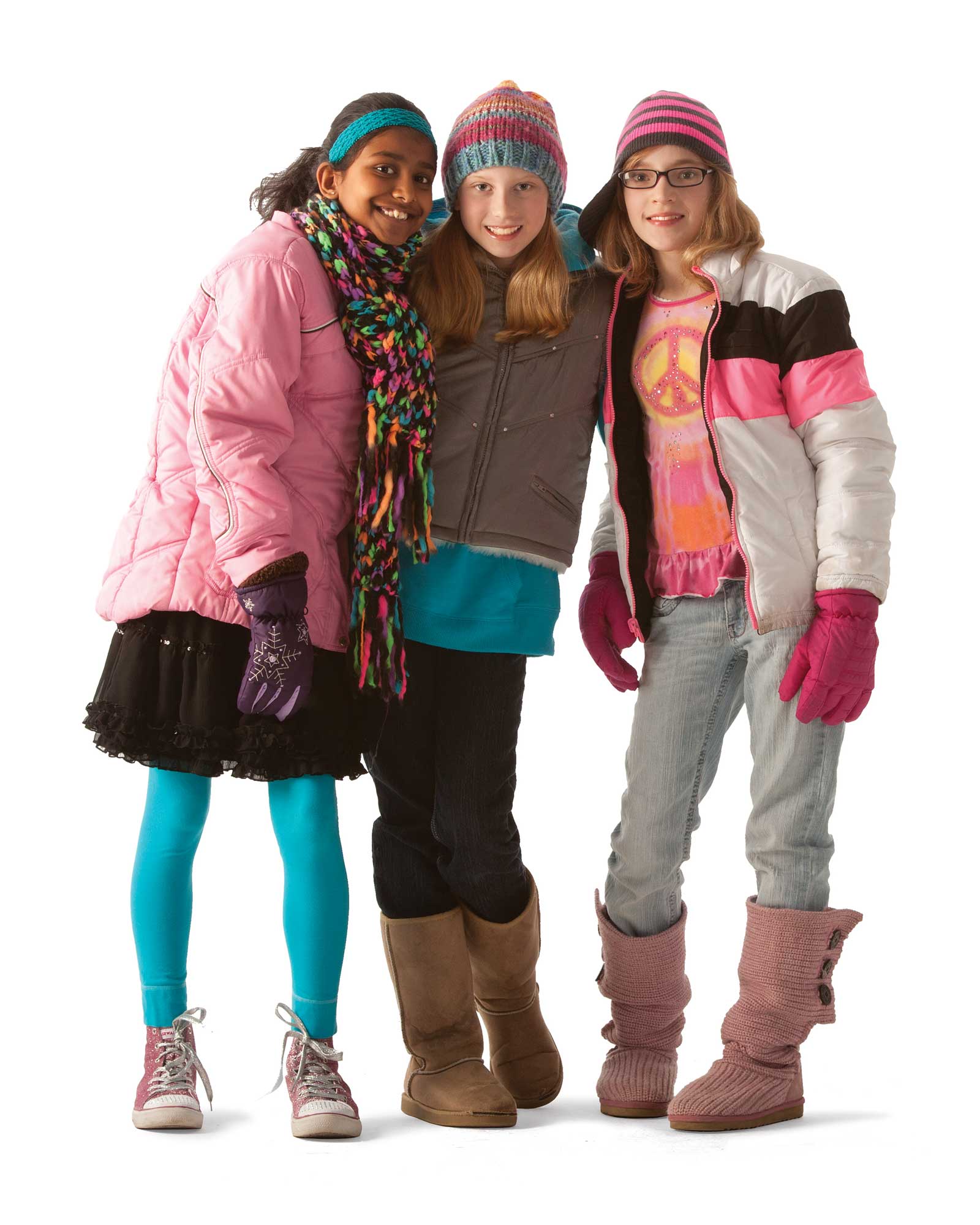 Three girls smiling in winter clothes.