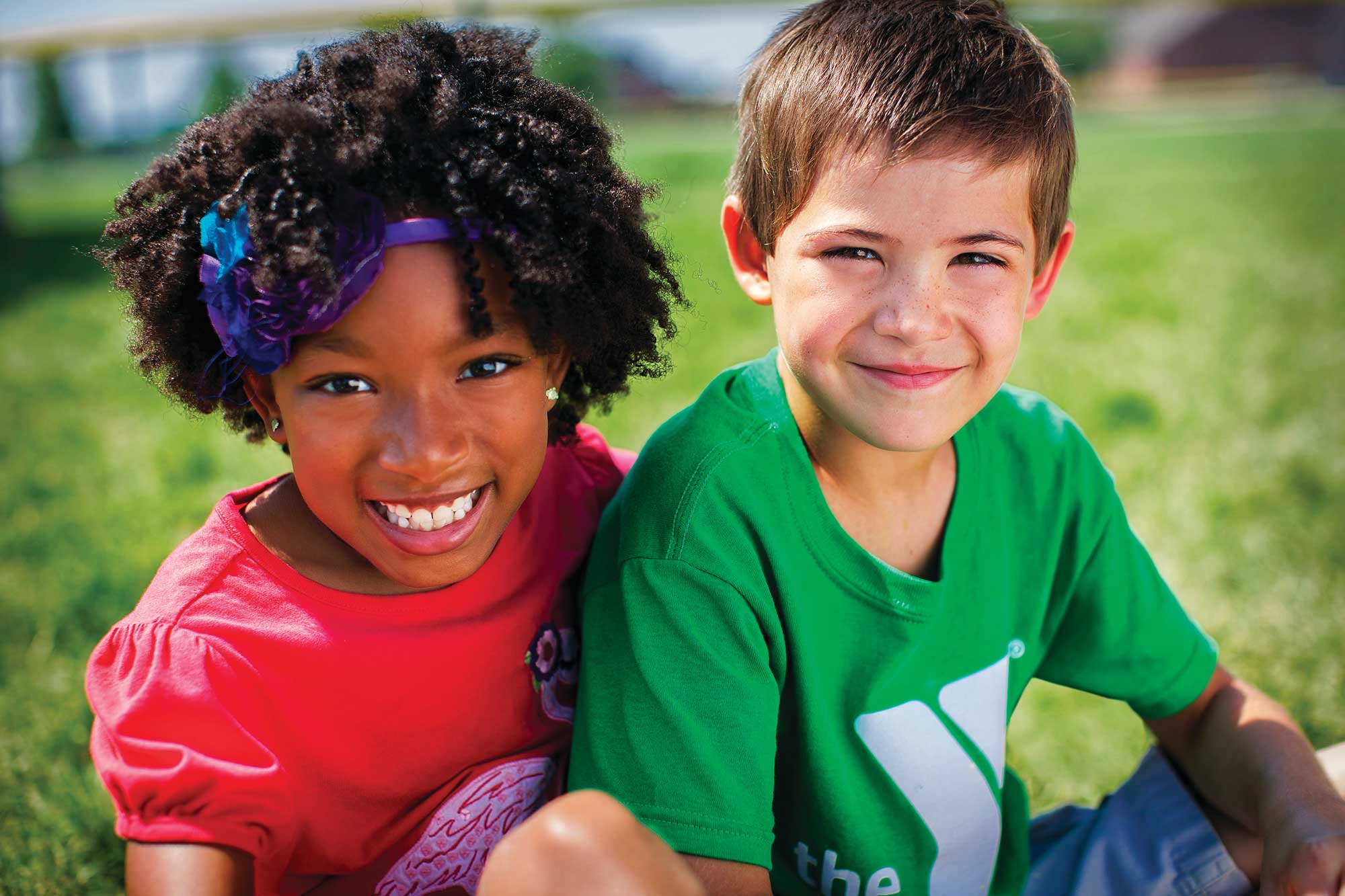 Young boy and girl smiling at the camera.