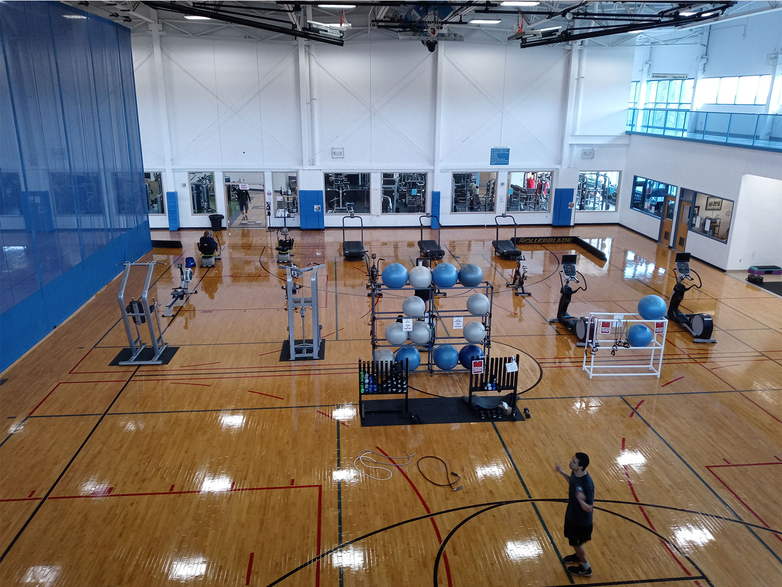 YMCA workout equipment and machines on basketball gym floor.
