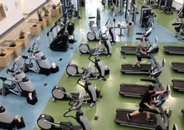 People working out on treadmills at the YMCA gym.