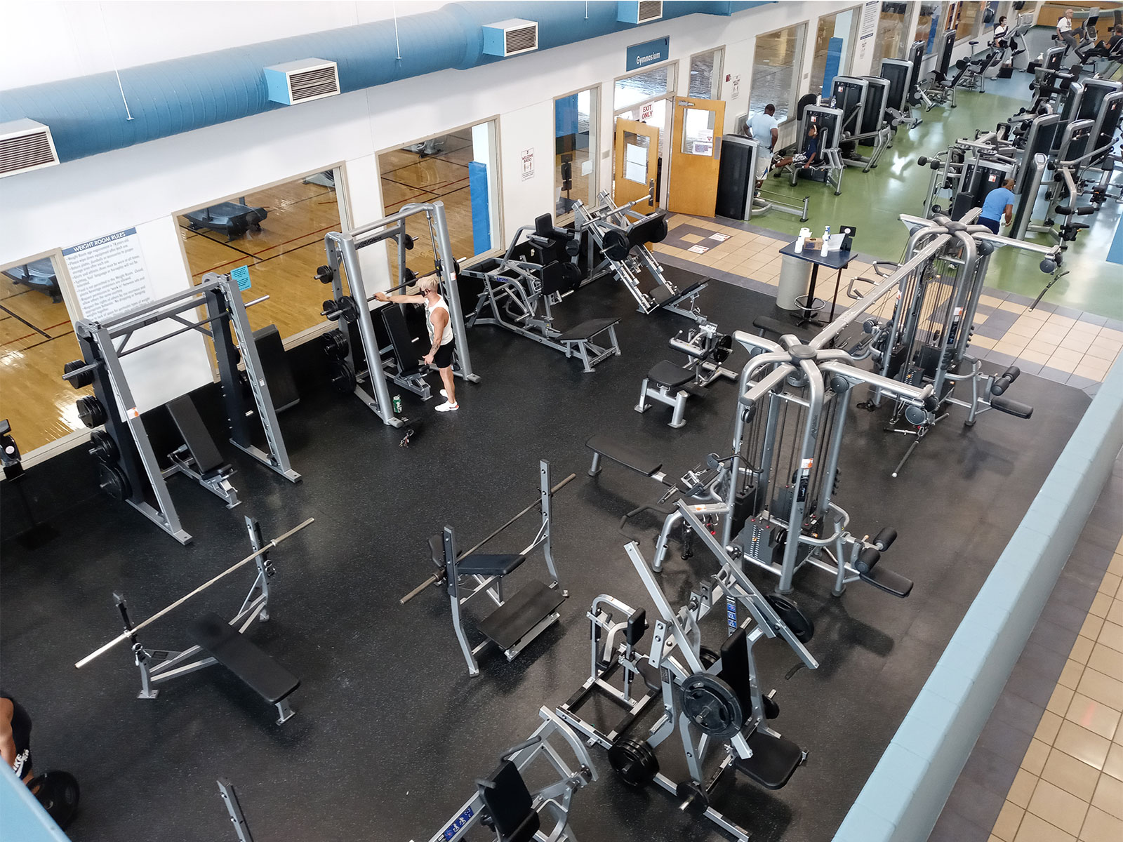 Two men working out in YMCA gym.