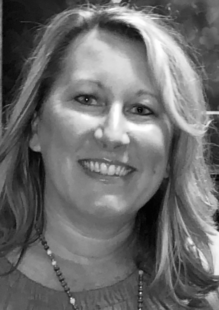Staff member Lisa smiling in a black and white photo.