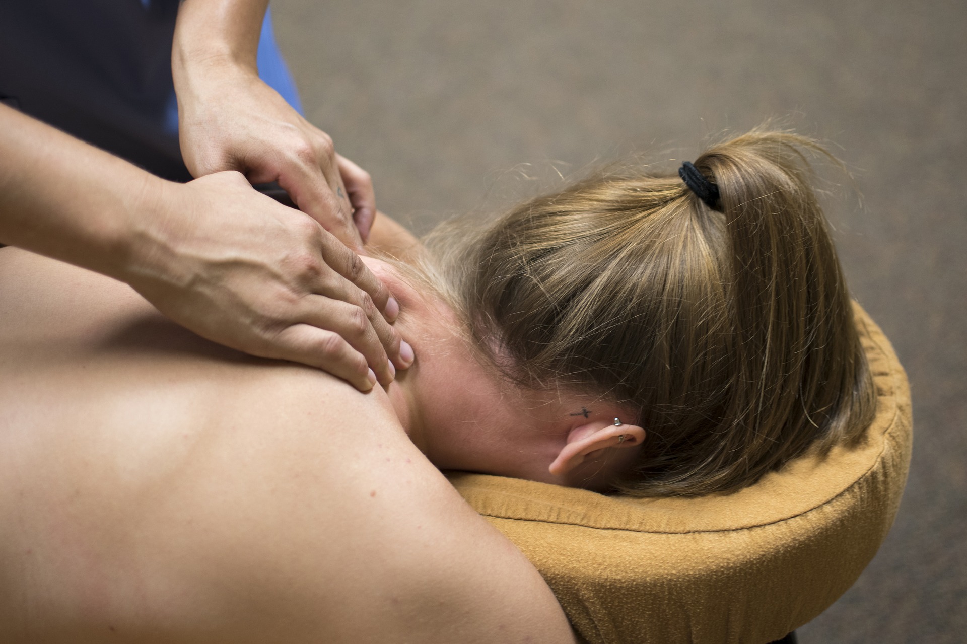 YMCA staff massages woman.