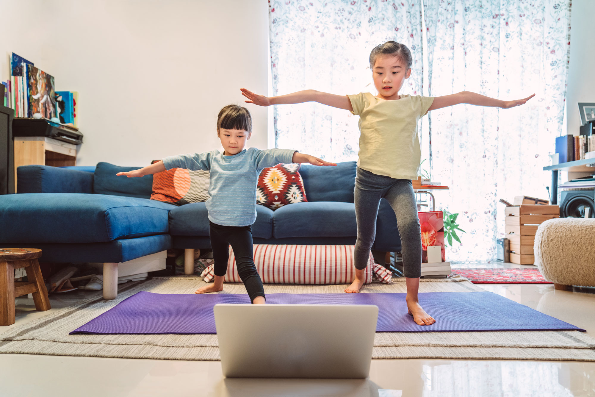 Two young girls with virtual YMCA membership working out in their living room. Two young girls with virtual YMCA membership working out in their living room.