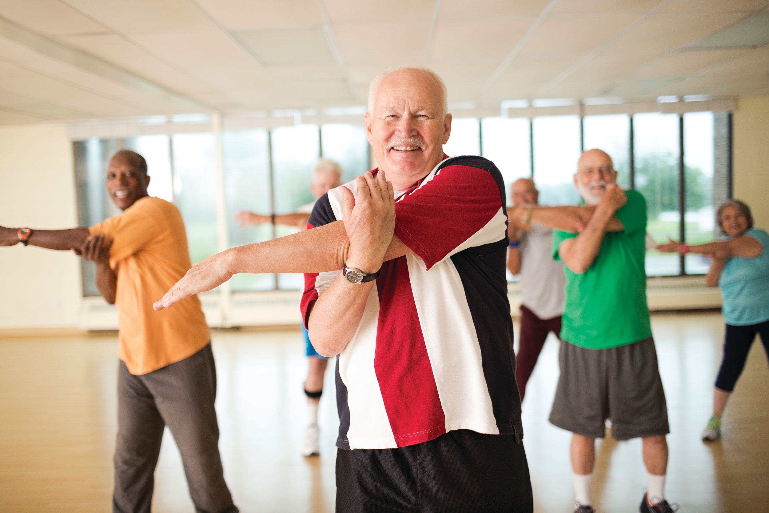 Male seniors enjoying an exercise class.