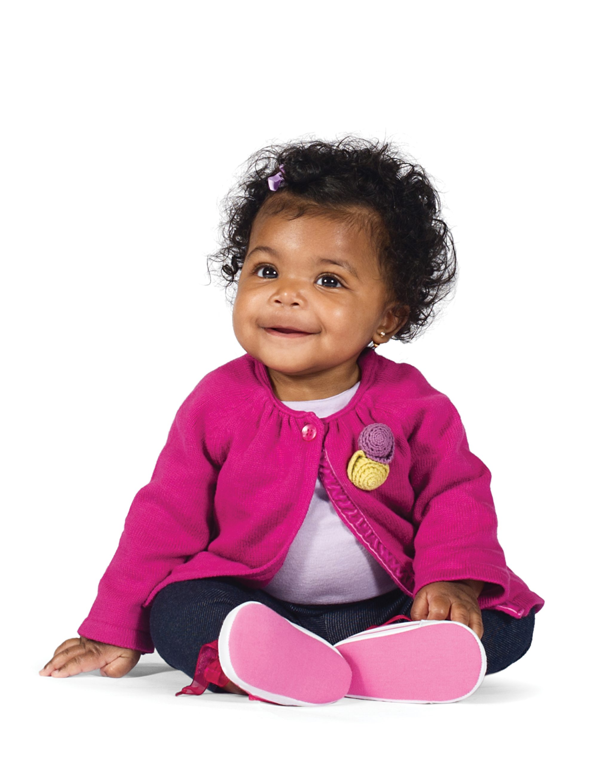 Sweet little girl smiling in a pink sweater. Sweet little girl smiling in a pink sweater.