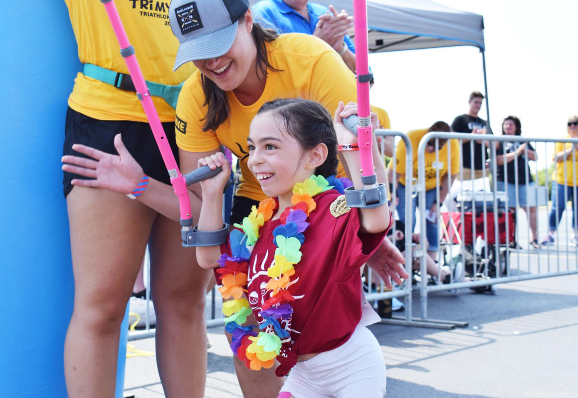 Young girl running the YMCA Tri My Best Triathlon.