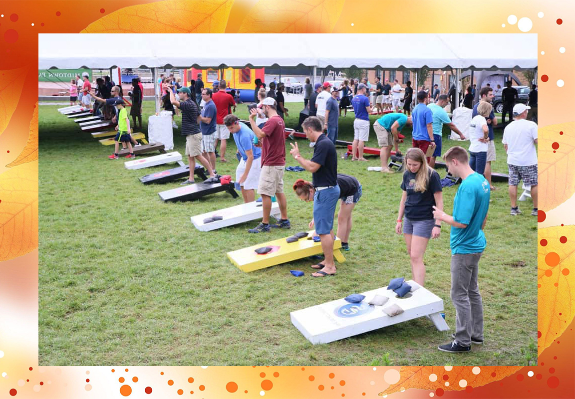 People playing in a bags tournament at the YMCA Fall Fest.