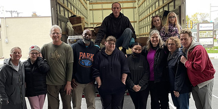 Group of adults smiling at the YMCA Turkey Donation.