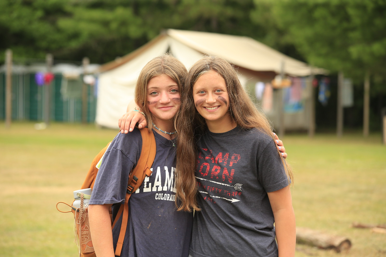 Two girl best friends hugging and smiling at the YMCA Camp.