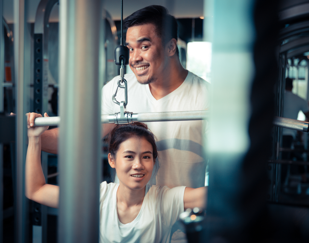 Fathering working out with daughter at the YMCA fitness center.