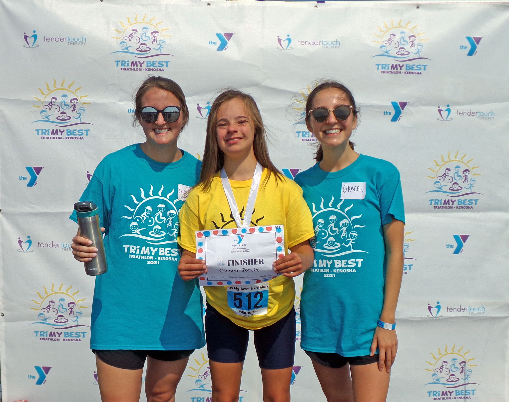 A Tri athlete poses with her athlete buddies after the race