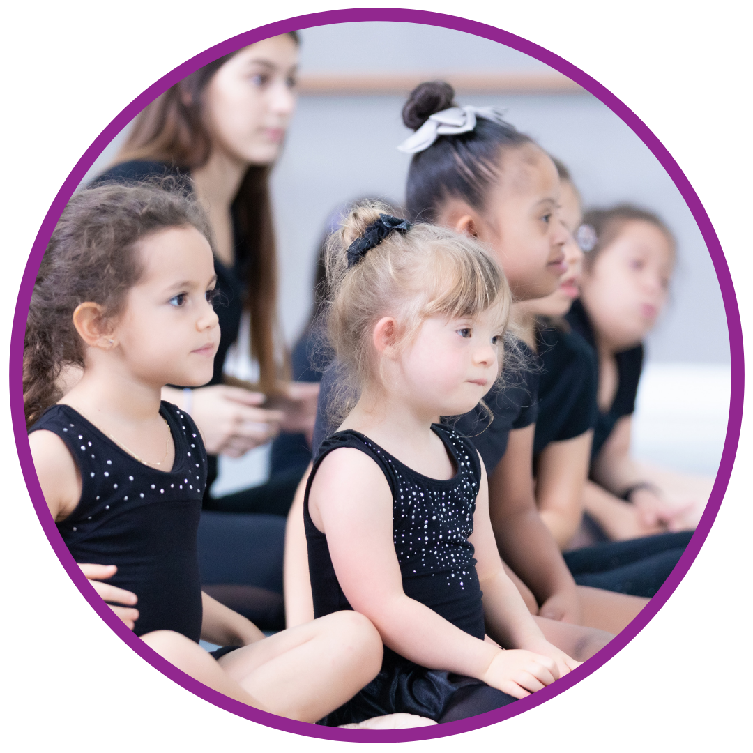 Young girl with Downs Syndrome listens in dance class