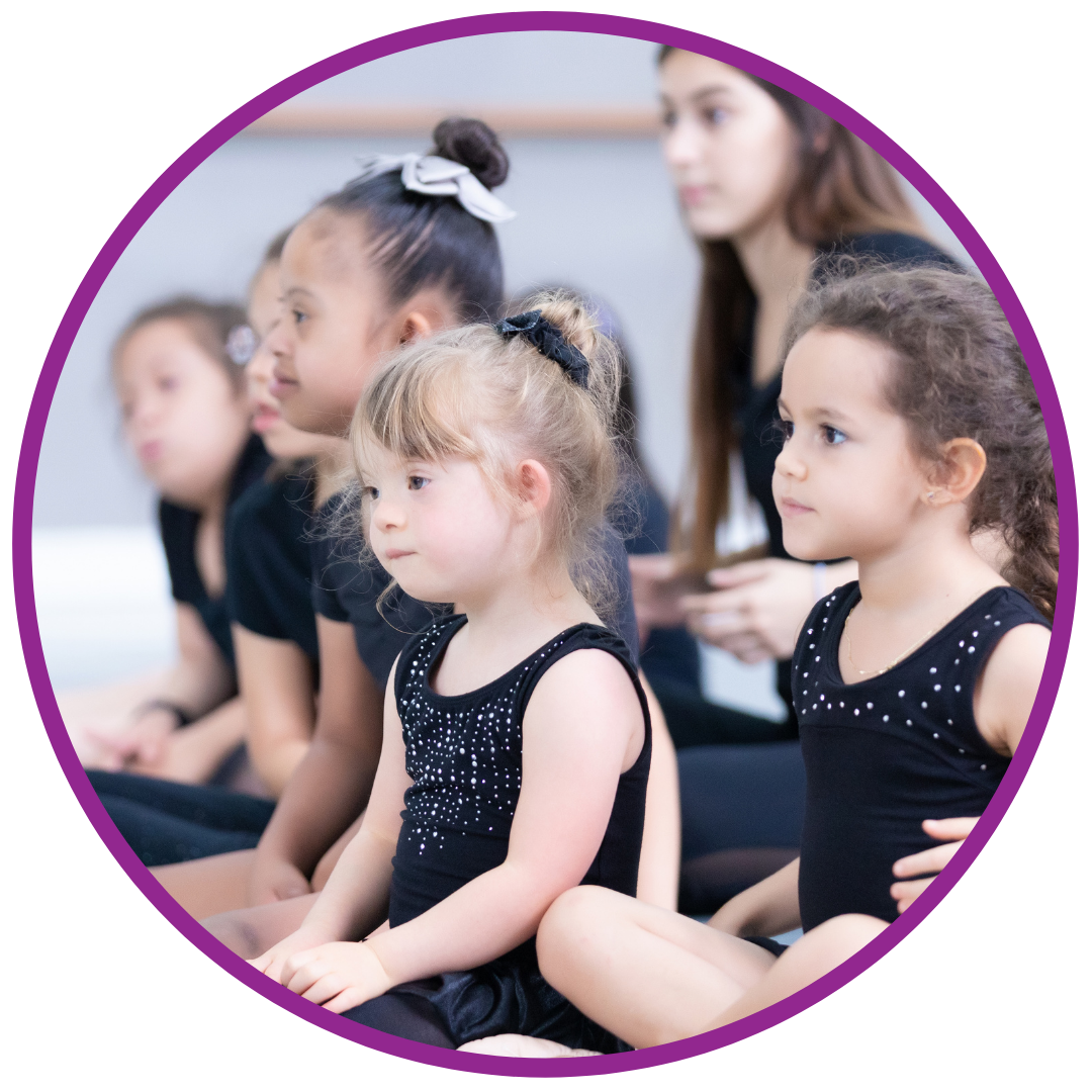Young girl with Downs Syndrome listens in dance class