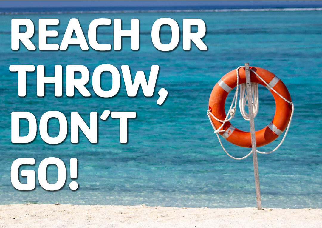 When someone is in trouble in the water -Reach, Don't Go. Orange life preserver with rope attached near the water