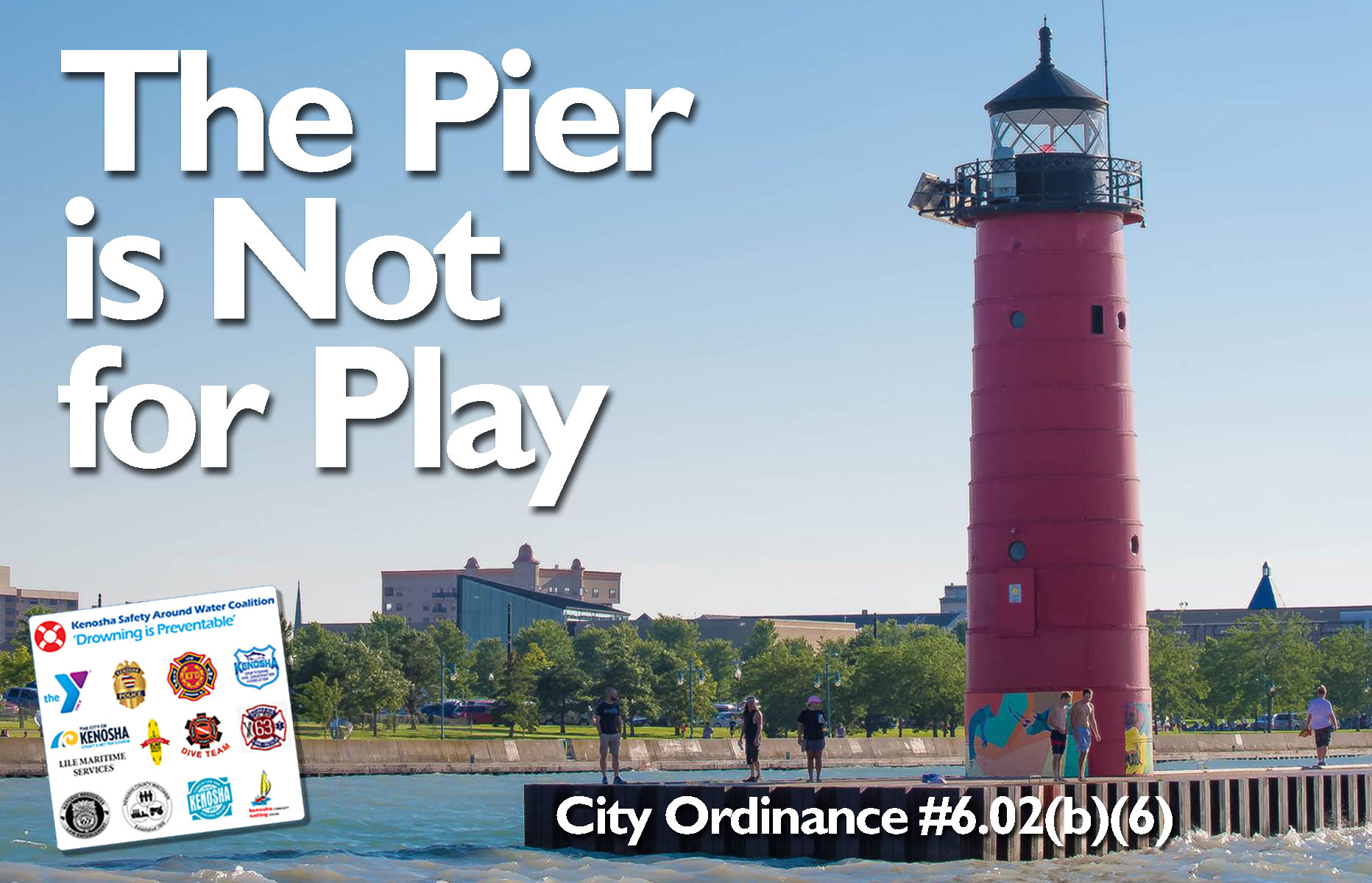 Red lighthouse at the end of the pier in Lake Michigan saying "The Pier is Not for Play"