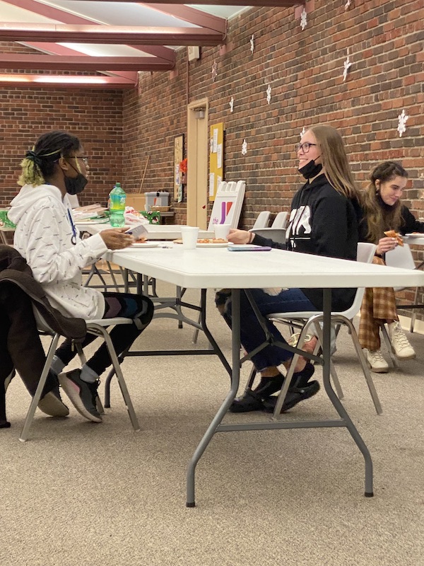 Three teen girls eating together at the YMCA.