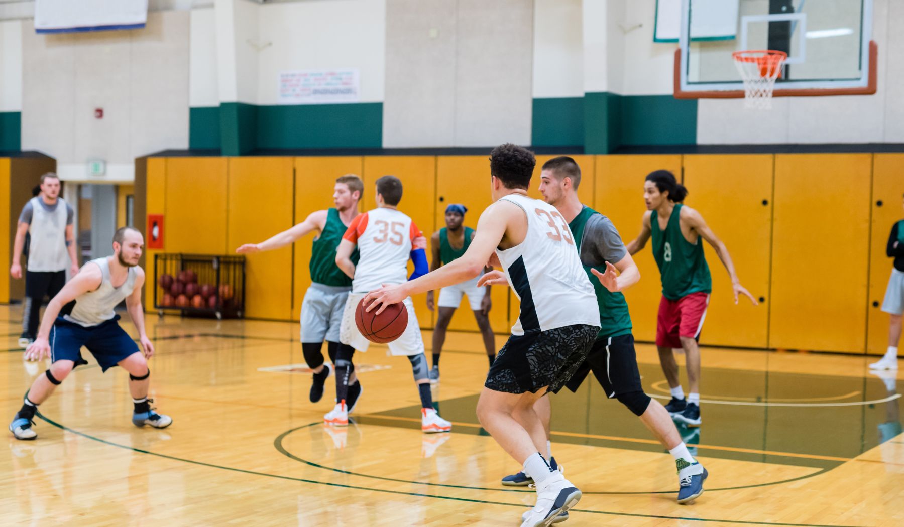 Adult men & women playing basketball